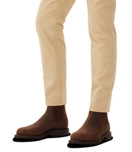 R.M Williams Brown Chelsea boots worn with beige pants on a white background